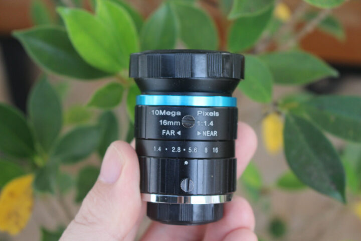 Camera lens focus exposure adjustment