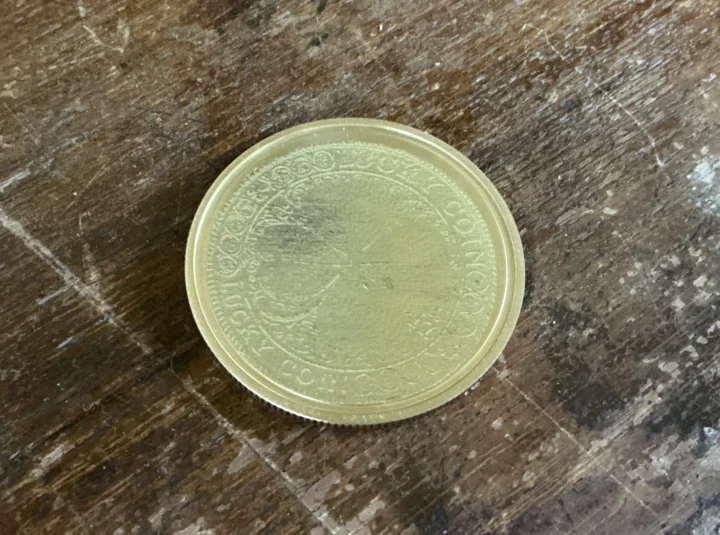 Brass coin with fiber laser